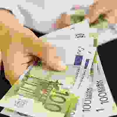 handing over cash - 100 euro notes