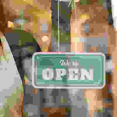 shop open sign in a doorway